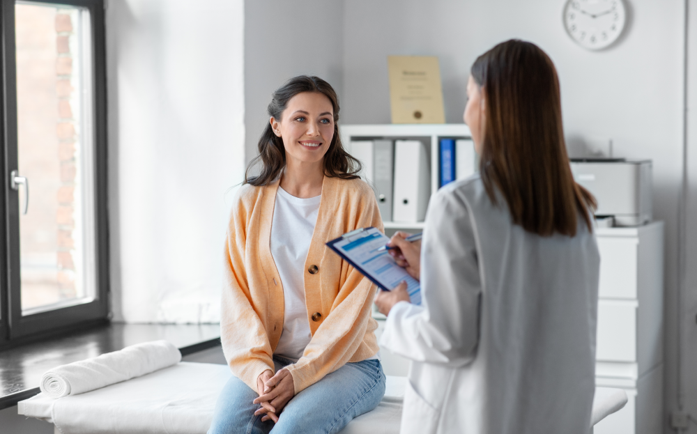Woman discussing BHRT options with a doctor in a clinic.